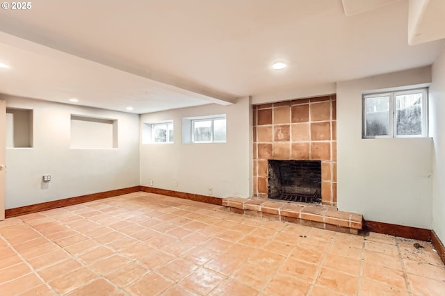 below grade area with recessed lighting, baseboards, and a large fireplace