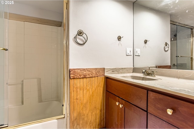 full bath featuring vanity and shower / bath combination with glass door