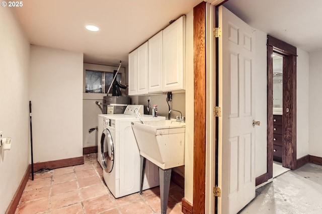 clothes washing area featuring recessed lighting, cabinet space, baseboards, and water heater