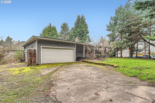 view of front facade featuring a front yard, driveway, a chimney, a garage, and board and batten siding