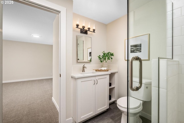 bathroom with toilet, baseboards, vanity, and a shower