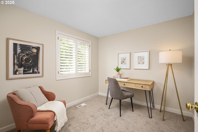 office space with light carpet and baseboards
