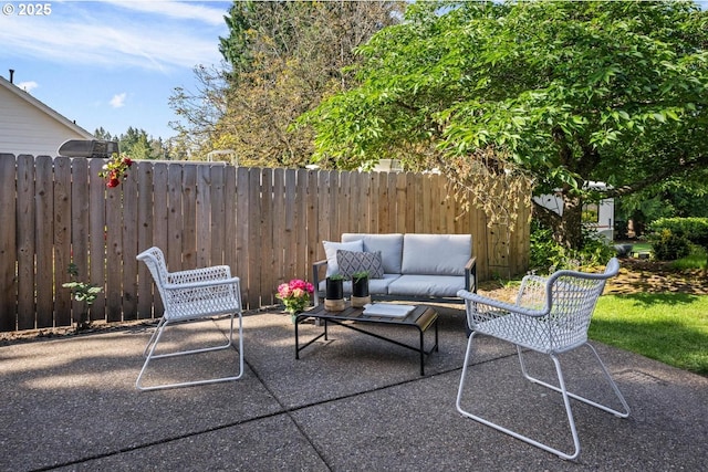 view of patio / terrace featuring outdoor lounge area and fence
