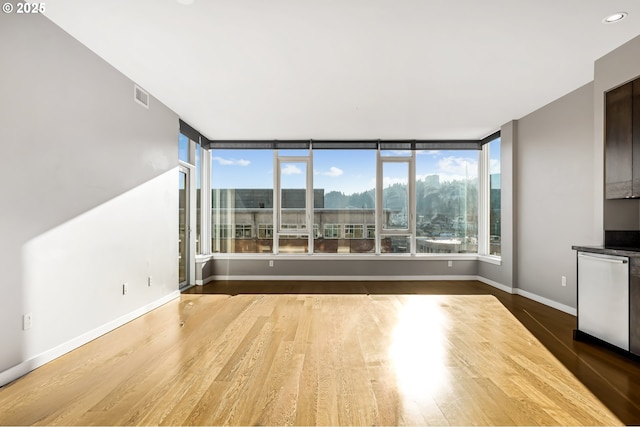 unfurnished living room with plenty of natural light and wood-type flooring