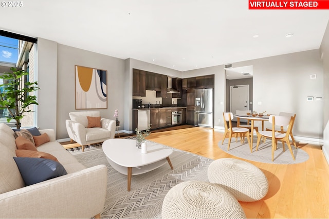 living room with sink and light hardwood / wood-style flooring