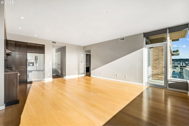 unfurnished living room featuring hardwood / wood-style flooring