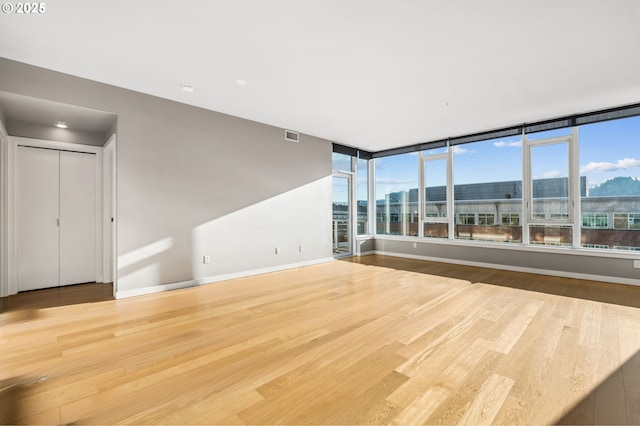 spare room with hardwood / wood-style floors