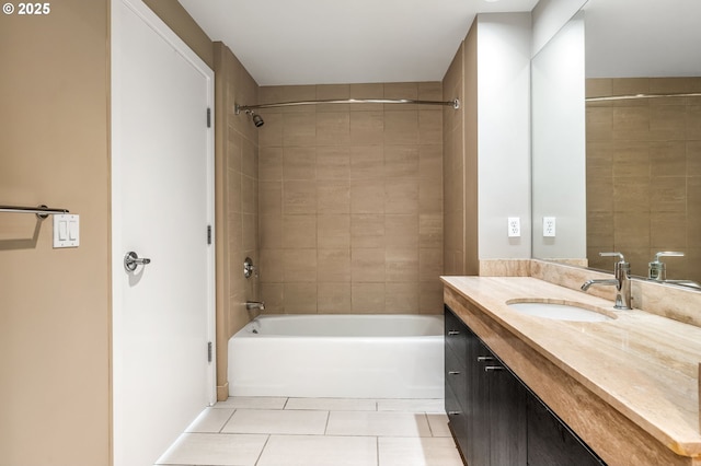 bathroom featuring vanity, tiled shower / bath combo, and tile patterned flooring