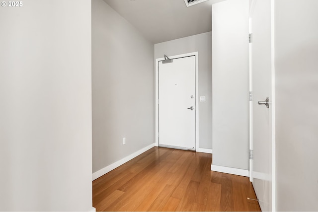 hallway with hardwood / wood-style flooring