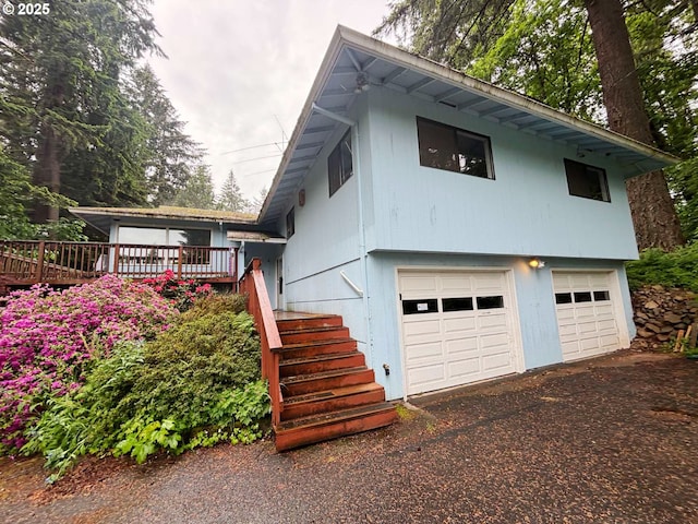 17373 SE Forest Hill Dr, Damascus, OR 97089 - view of front of property with a garage, stairway, a deck, and driveway