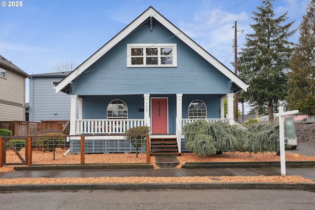 bungalow-style home featuring a fenced front yard and a porch