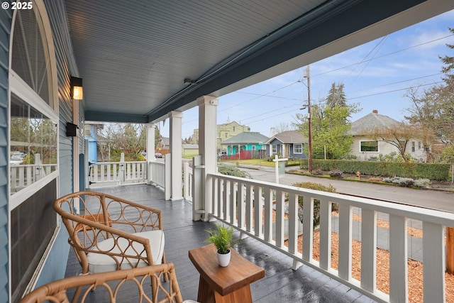 balcony featuring covered porch and a residential view