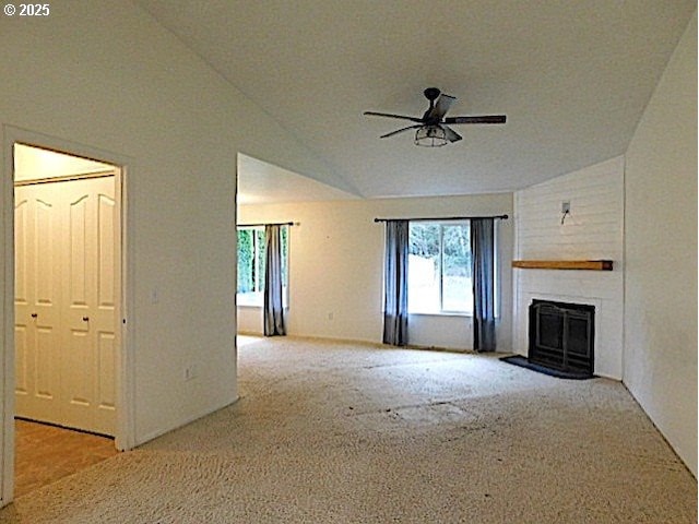 unfurnished living room featuring ceiling fan, light colored carpet, and lofted ceiling