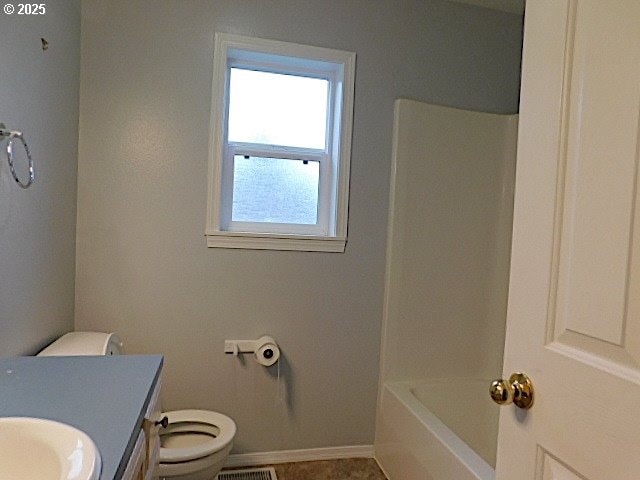 full bathroom with tile patterned floors, washtub / shower combination, vanity, and toilet