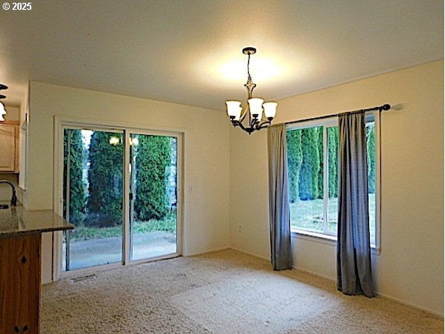 unfurnished dining area featuring a wealth of natural light and an inviting chandelier