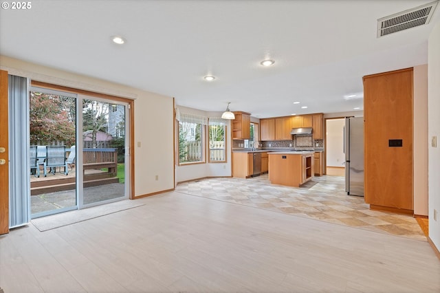 14100 SE 20th St, Vancouver, WA 98683 - kitchen with stainless steel appliances, open shelves, baseboards, backsplash, and open floor plan