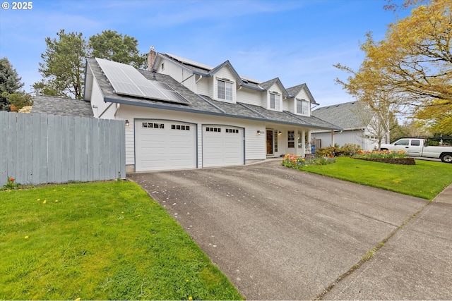 14100 SE 20th St, Vancouver, WA 98683 - cape cod-style house featuring a garage, asphalt driveway, solar panels, and a porch