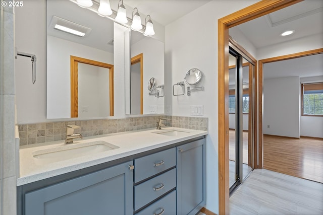 14100 SE 20th St, Vancouver, WA 98683 - bathroom with double vanity, decorative backsplash, and wood finished floors