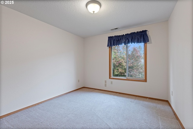 14100 SE 20th St, Vancouver, WA 98683 - spare room featuring light colored carpet, a textured ceiling, and baseboards