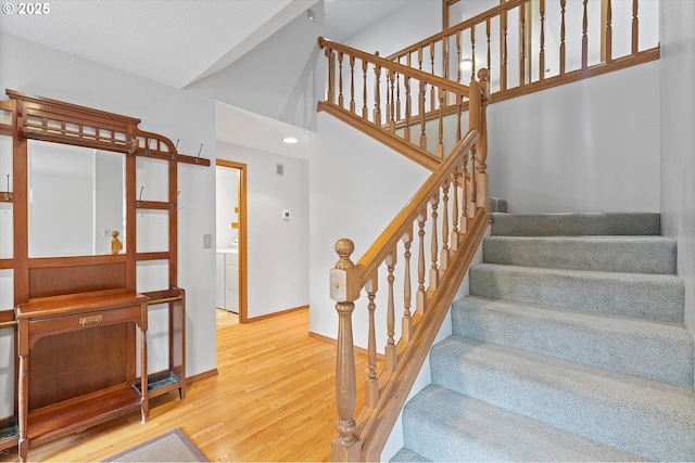 14100 SE 20th St, Vancouver, WA 98683 - stairs featuring wood finished floors, washer / clothes dryer, baseboards, and recessed lighting