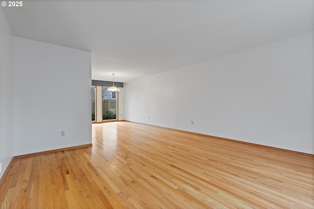 14100 SE 20th St, Vancouver, WA 98683 - spare room featuring a chandelier and light wood-type flooring