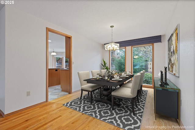 14100 SE 20th St, Vancouver, WA 98683 - dining room with light wood-style floors, a chandelier, and baseboards