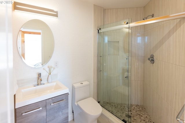 full bath with vanity, toilet, and a shower stall