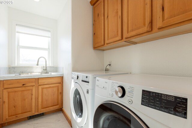 laundry area featuring a sink, cabinet space, visible vents, independent washer and dryer, and marble finish floor