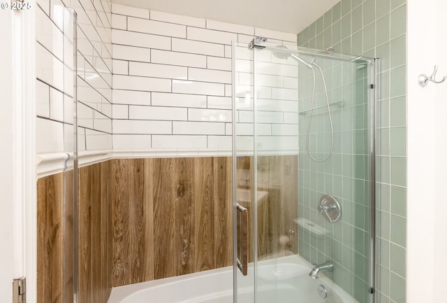 bathroom featuring bath / shower combo with glass door