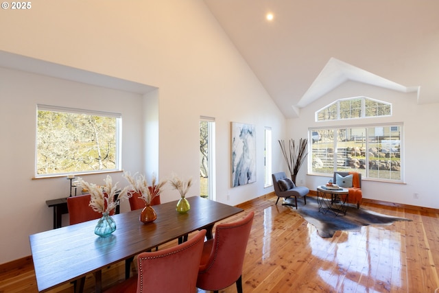dining room featuring recessed lighting, wood finished floors, and high vaulted ceiling