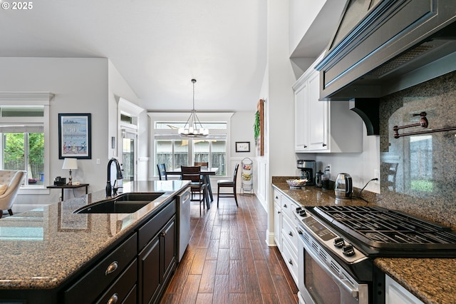 1622 Provincial Way, Eugene, OR 97401 - kitchen with appliances with stainless steel finishes, a chandelier, white cabinetry, dark wood-type flooring, and decorative backsplash