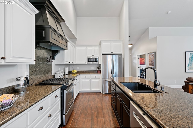1622 Provincial Way, Eugene, OR 97401 - kitchen with appliances with stainless steel finishes, dark stone countertops, white cabinetry, and high vaulted ceiling
