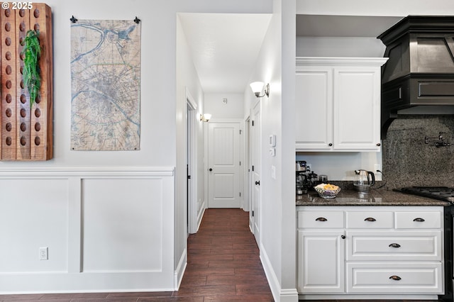 1622 Provincial Way, Eugene, OR 97401 - kitchen with dark wood finished floors, white cabinets, dark stone counters, exhaust hood, and backsplash