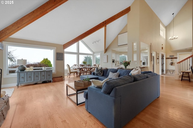 living room featuring an inviting chandelier, beam ceiling, light hardwood / wood-style flooring, and high vaulted ceiling