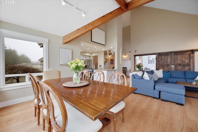 dining area with track lighting, beam ceiling, high vaulted ceiling, and light hardwood / wood-style flooring