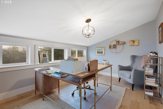 office space with vaulted ceiling, a chandelier, and light wood-type flooring