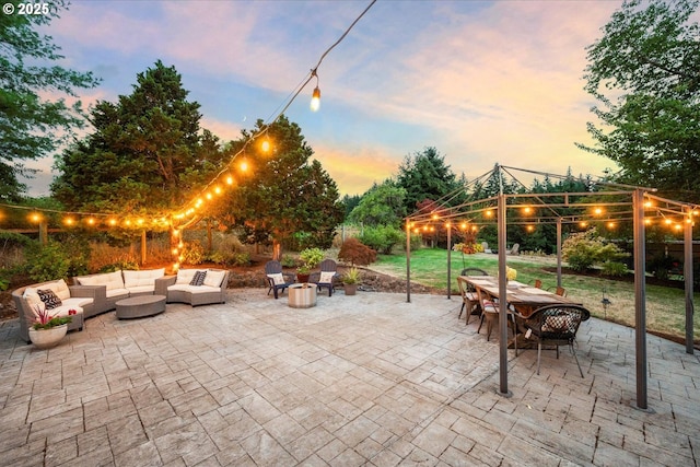 patio terrace at dusk featuring a gazebo and an outdoor living space with a fire pit