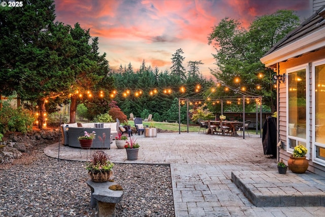 patio terrace at dusk featuring an outdoor living space and a gazebo