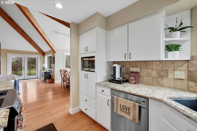 kitchen featuring appliances with stainless steel finishes, backsplash, light stone countertops, light hardwood / wood-style floors, and white cabinets