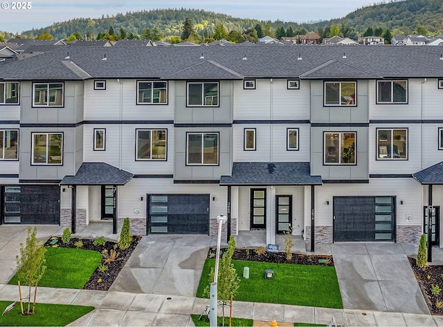 view of property with a mountain view and a garage