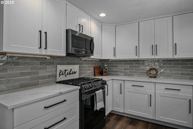 1552 59th Ave SE, Salem, OR 97317 - kitchen featuring black range with gas stovetop, white cabinetry, dark wood-style floors, light stone counters, and recessed lighting