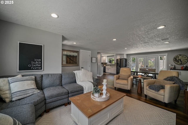 1552 59th Ave SE, Salem, OR 97317 - living room featuring wood finished floors, a textured ceiling, recessed lighting, and french doors