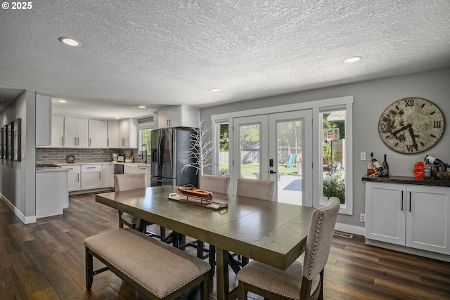 1552 59th Ave SE, Salem, OR 97317 - dining space featuring french doors, dark wood-type flooring, recessed lighting, a textured ceiling, and baseboards