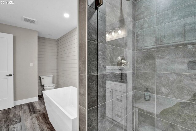 2034 45th St, Florence, OR 97439 - full bathroom featuring toilet, tiled shower, wood finished floors, baseboards, and visible vents