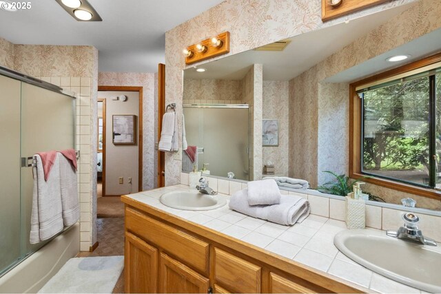 863 Fairway View Dr, Eugene, OR 97401 - bathroom with wallpapered walls, shower / bath combination with glass door, and double vanity