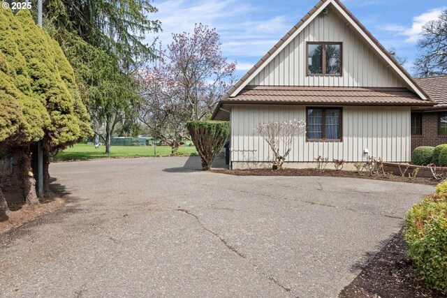 863 Fairway View Dr, Eugene, OR 97401 - view of property exterior featuring board and batten siding and asphalt driveway