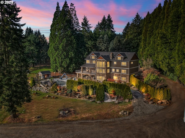 back house at dusk with a balcony