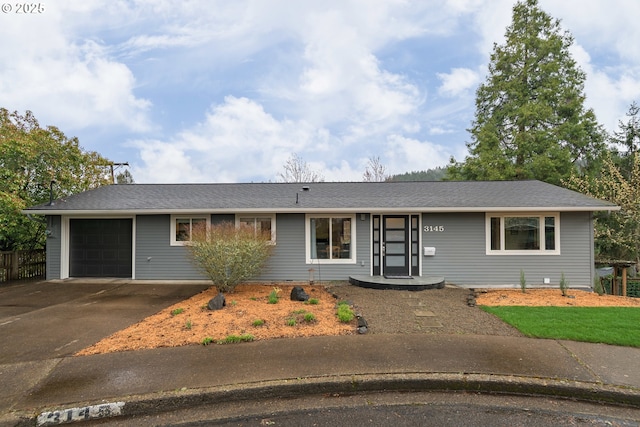 ranch-style home with a garage and driveway