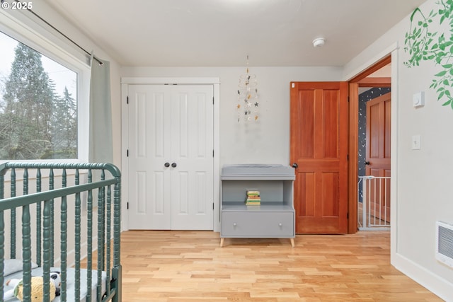 bedroom with light wood-type flooring and a closet