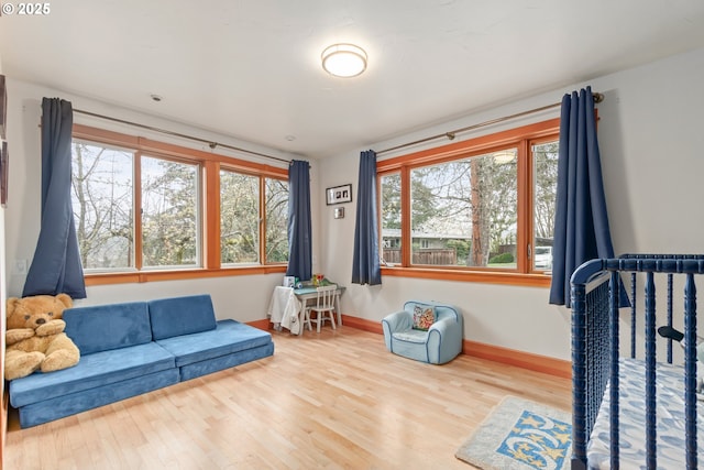 sitting room featuring baseboards and wood finished floors